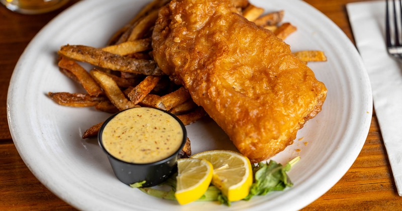 Fish and chips  with a side of remoulade and  a glass of Lafayette Lager