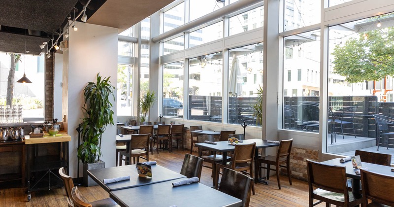 Interior, spacious dining area with large windows and view on patio