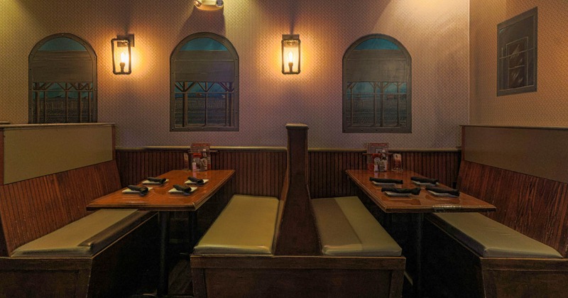 Dining area, seating booths, tables set for guests