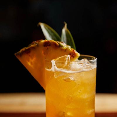 Cocktail with pineapple wedge.