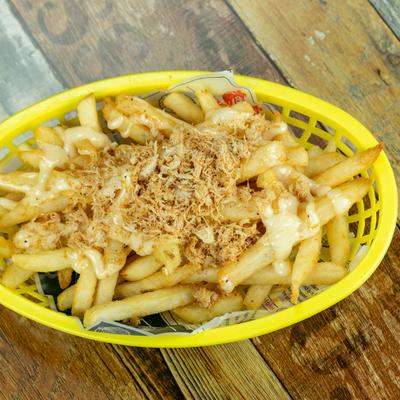 Crab meat fries served in a yellow basket.