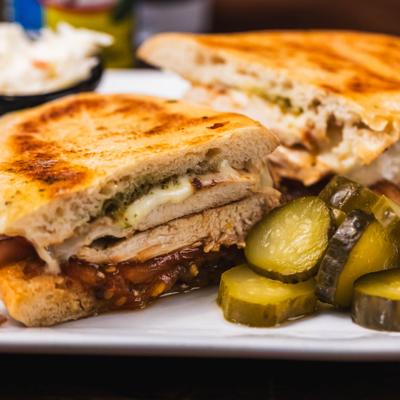 Chicken Panini served with pickes and coleslaw.
