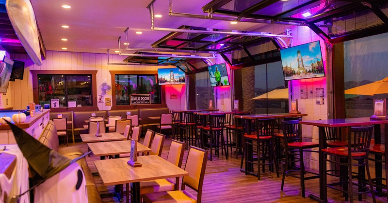 Interior seating area with neon lighting and wooden furniture