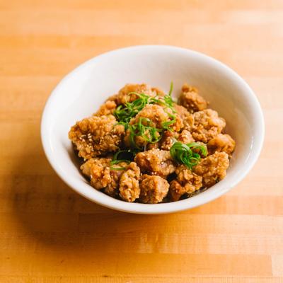 Crispy fried chicken bites with green onions.