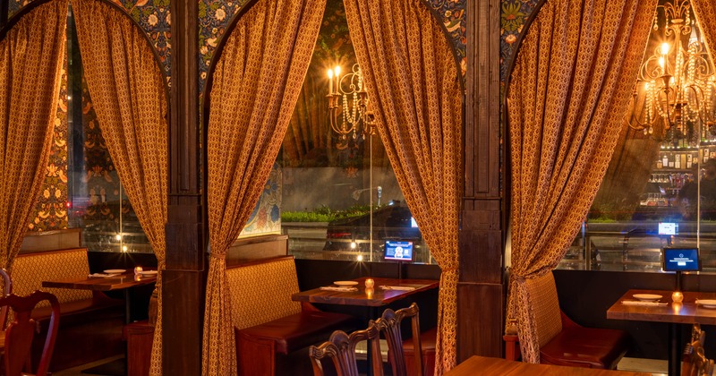 Interior, dining area, separated booths, seating by the windows, curtains for privacy