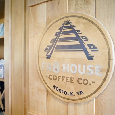 FR8 House Coffee Co sign on an indoor wall.