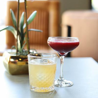 Peach Cardamom Crush, blackberry cocktail and a potted plant