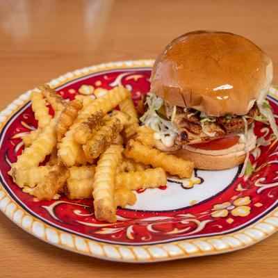 Grilled chicken sandwich with fries on the side.