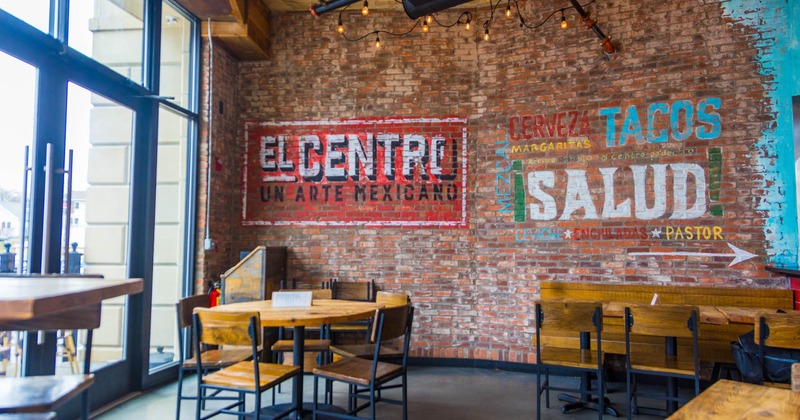 Interior, dining area, restaurant entrance, tables with chairs, vintage red brick wall