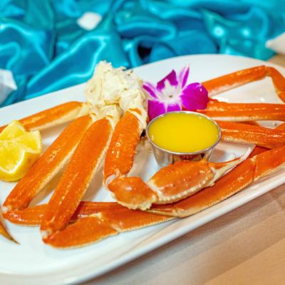 Snow crab legs with melted butter and lemon slices.