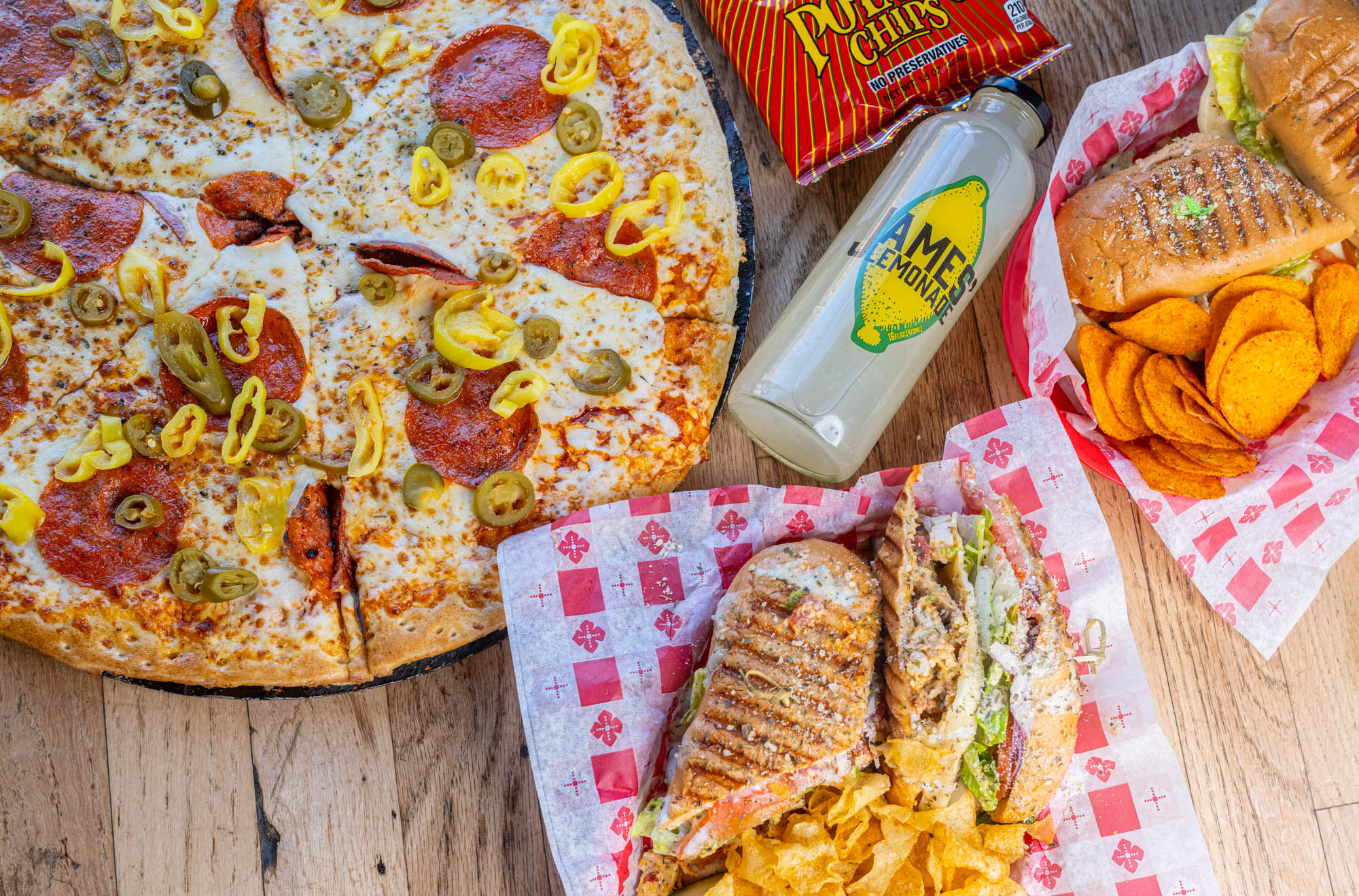 Pizza, sandwiches, drinks, and snacks, top view