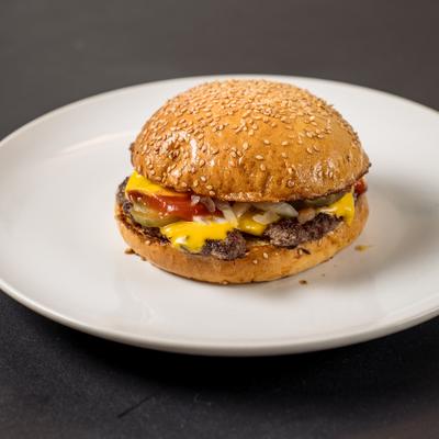 Classic Cheeseburger topped with diced onions, ketchup and pickles.