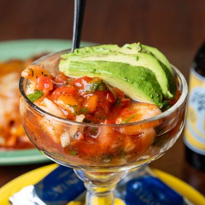 Shrimp cocktail topped with avocado slices.