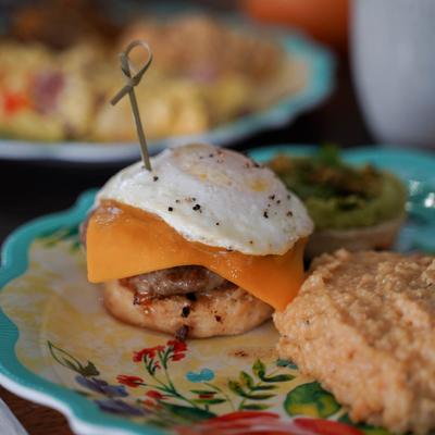 Sausage, Egg, and Cheese Biscuit sandwich with grits.