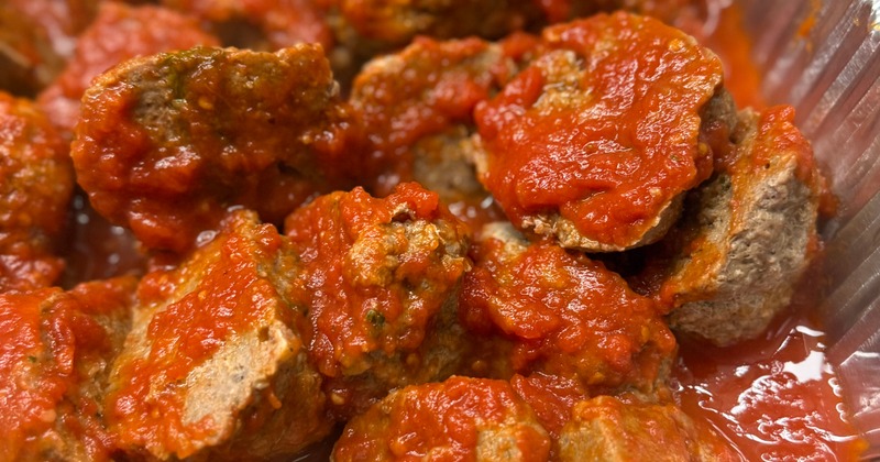 Meatballs with tomato sauce in a foil tray