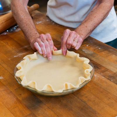 Baker making a pie.