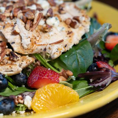 Grilled chicken salad, with greens, berries, mandarins, blue cheese, and pecans.