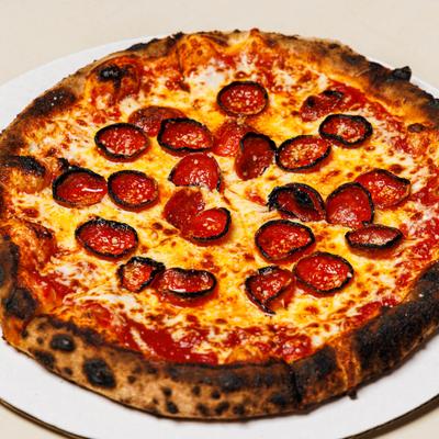 Pepperoni Pizza served on a white plate.