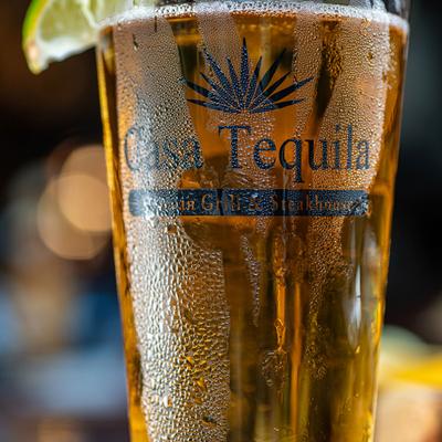 A glass of beer with lime wedge.