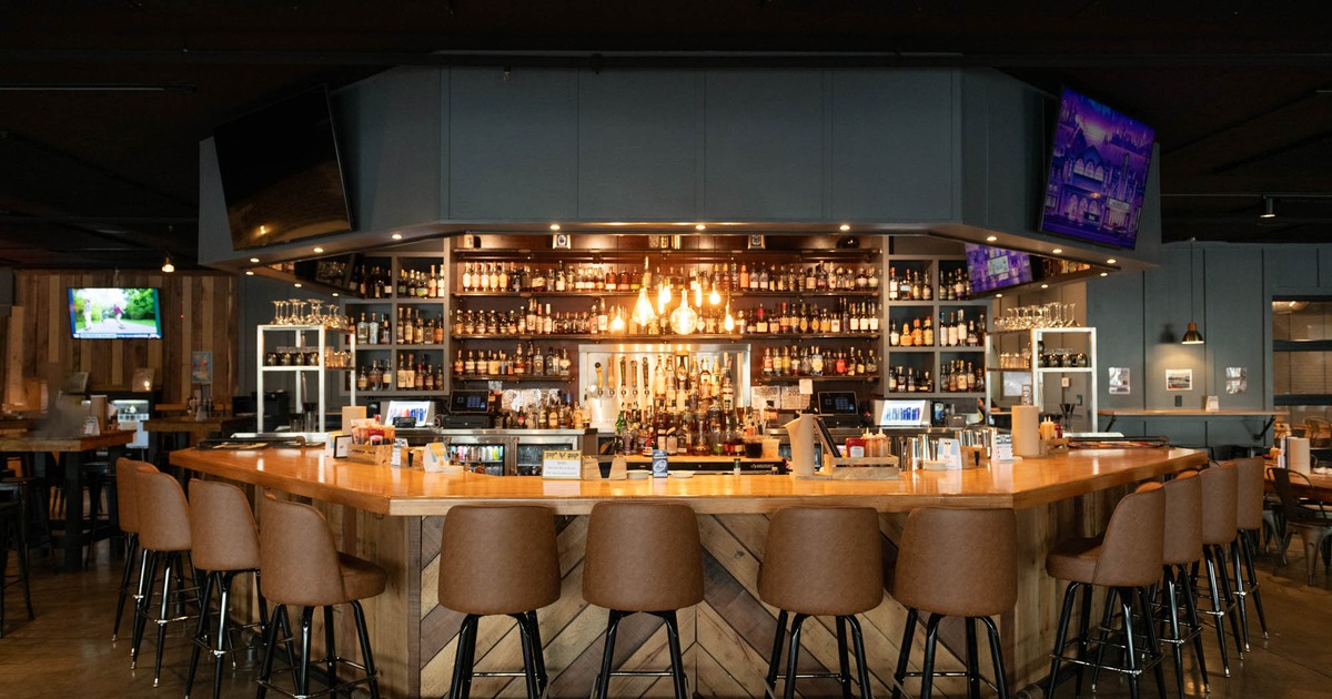 Interior, bar area, wooden top bar with leather padded stools, large over the wall drink shelf
