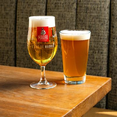 Two glasses of beer served on the table.