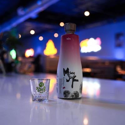 A bottle of black raspberry wine and a glass