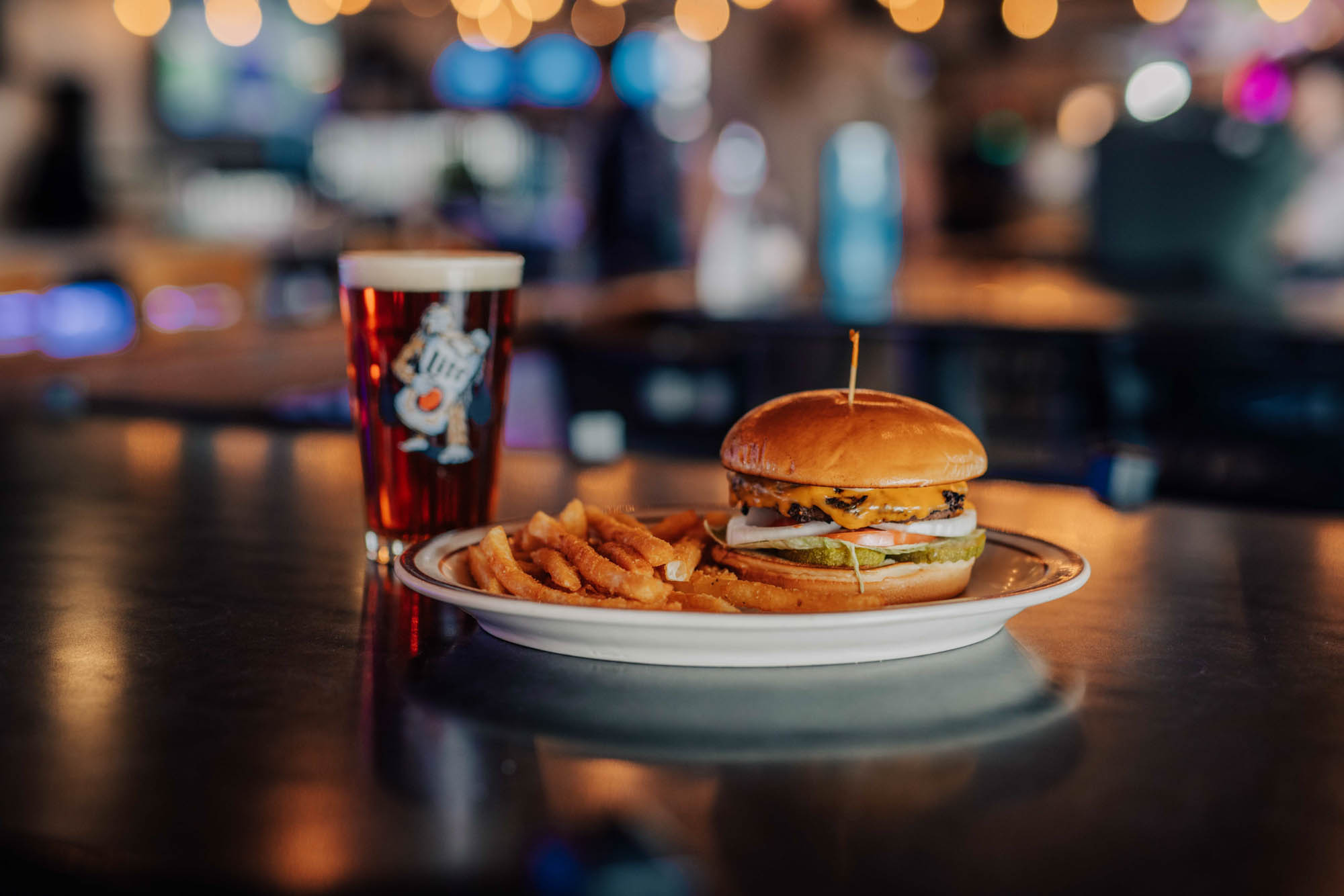 Cheeseburger with fries and a glass of beer