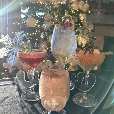 Festive drinks set against a sparkling Christmas tree.