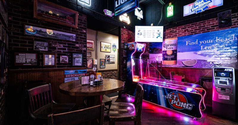 Interior, round table,chairs, play mashine behind