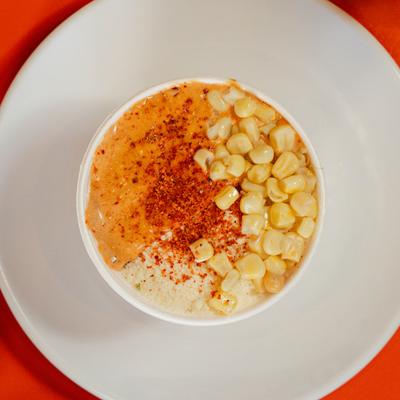 A cup with crema chili corn.