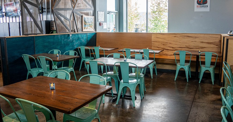 Interior, separated dining area, long wooden banquette bench with tables and chairs