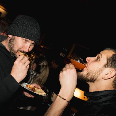 Two guests enjoying food and drinks.
