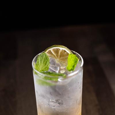 Cocktail, decorated with lime wedge and mint leaves
