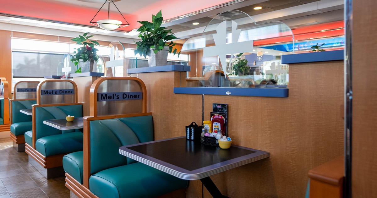 Interior, dining area, seating booths with tables for two, condiments on the tables