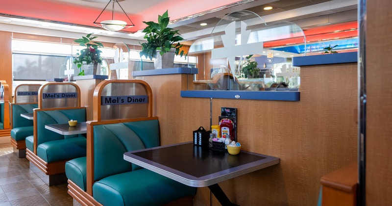 Interior, dining area, seating booths with tables for two, condiments on the tables
