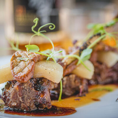 Grilled meat with sauce and vegetables closeup