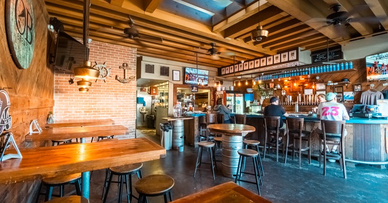 Interior, seating area with few guests in the back