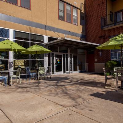 Tables and chairs under parasols outside.