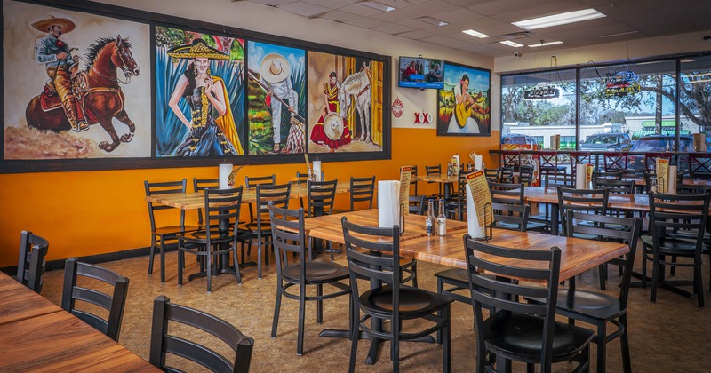 Interior seating area with chairs and tables, wall decoration