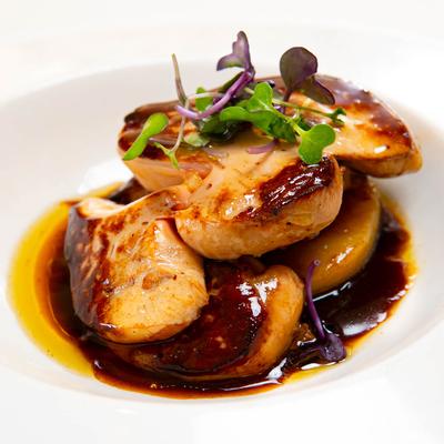 Pan seared duck liver, with caramelized white peach, and port wine sauce.