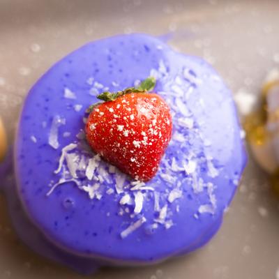 Malasada style pancakes with strawberry on top.