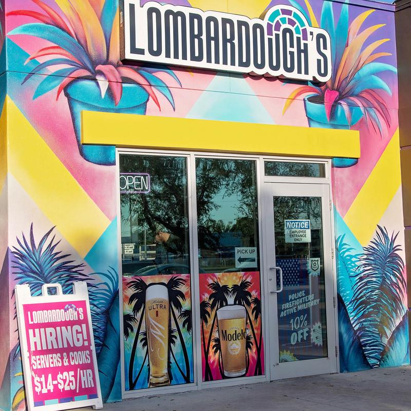 Exterior of a restaurant with a sign indicating they are hiring.