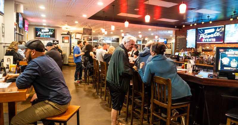 Interior, guests sitting at tables and bar counter