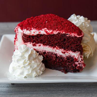 Red velvet cake with whipped cream.