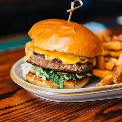 Cheeseburger, with caramelized onions, lettuce, pickles, fries, and house burger sauce.