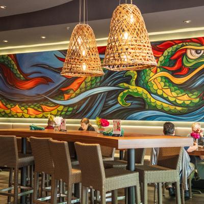 Interior, dining area, basket style pendant lights and a large scale mural of a dragon.