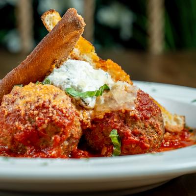 Wagyu Meatballs served with a dollop of ricotta, fresh basil, and toasted bread.