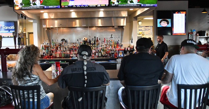 Bar. guests, tv screens above