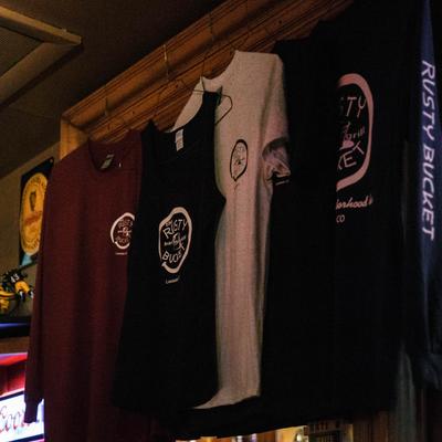 Merchandise t-shirts on a wall inside