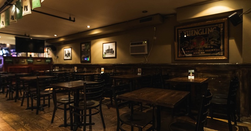 Interior, upstairs seating area, wooden tables and chairs, ready for guests, hardwood flooring